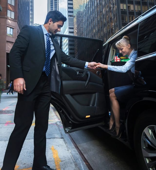 Gloved chauffeur hand opening car door
